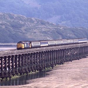 37429 crosses the Mawddach estuary at Barmouth, operating the summer Saturday Euston to Pwllheli service, August 1990.