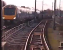 Photo taken from a Tram showing the tram tracks, a small barrier and a Class 195