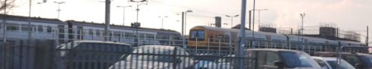 Photo of a WMT livery Class 323, in Wigan North Western, seen from the line from Wallgate, a Northern Class 156 is also visible.