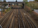 4 tracks, 2 tram, 2 train, alongside each other, a track crosses between the middle two tracks, connecting the Southbound Tram and Northbound train lines