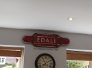 a damaged sign saying EDALE with the words The Original Station Sign