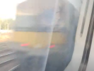 Blurry photo of a Class 321 seen out a Class 390 window.