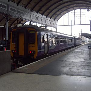 A Class 156 waits in Platform 1.