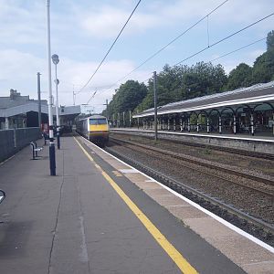 An IC225 set draws out of the station with a train to London.