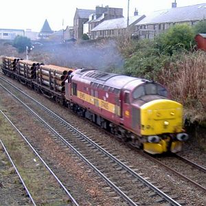 37405 heads North out of Arbroath with a pipe train for Aberdeen