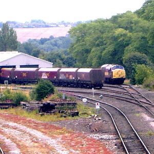 A Class 37 and EWS wagons sit outside the shed at Tyne Yard.