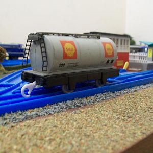 The Hornby tank wagon body is a good match in length and width, for the Plarail chassis, requiring very little work, other than trimming some plastic