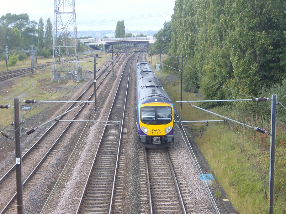 185 132 passes the northern end of the yard with a Newcastle - Manchester Airport service.