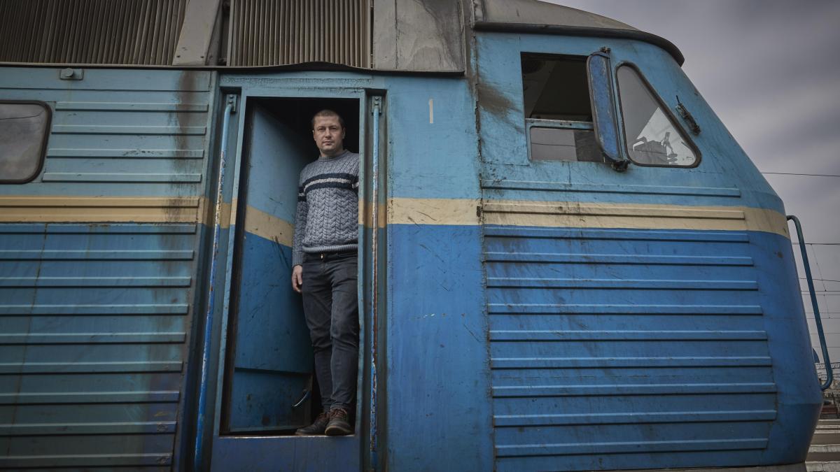 Andriy Bobrovskiy in the cab of the train he drives between Kyiv and Lviv