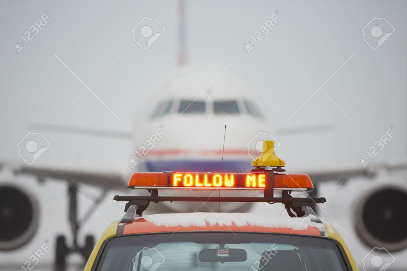 17175494-Follow-me-car-on-airport-Stock-Photo.jpg